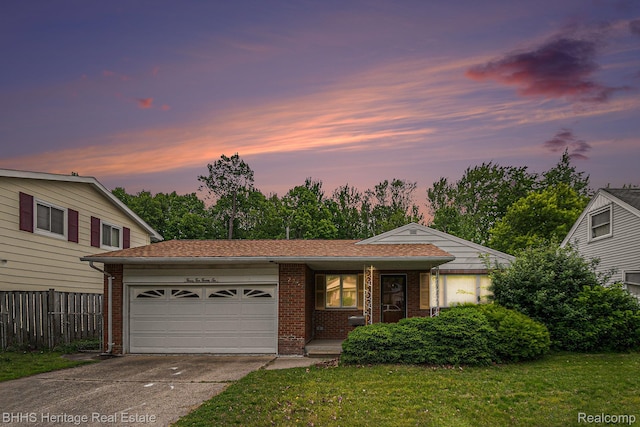3226 Glasgow Dr, Lansing, MI 48911 - view of front facade featuring brick siding, an attached garage, concrete driveway, and covered porch
