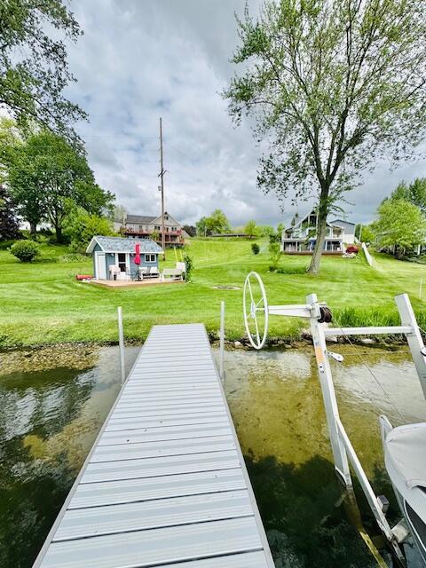 1022 Ottland Shrs, Lake Odessa, MI 48849 - dock area with a lawn and a water view