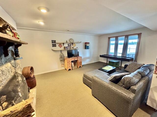 1022 Ottland Shrs, Lake Odessa, MI 48849 - living area with carpet flooring, crown molding, and baseboards