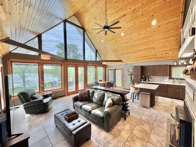 1022 Ottland Shrs, Lake Odessa, MI 48849 - living room with wooden ceiling, high vaulted ceiling, ceiling fan, light tile patterned floors, and plenty of natural light