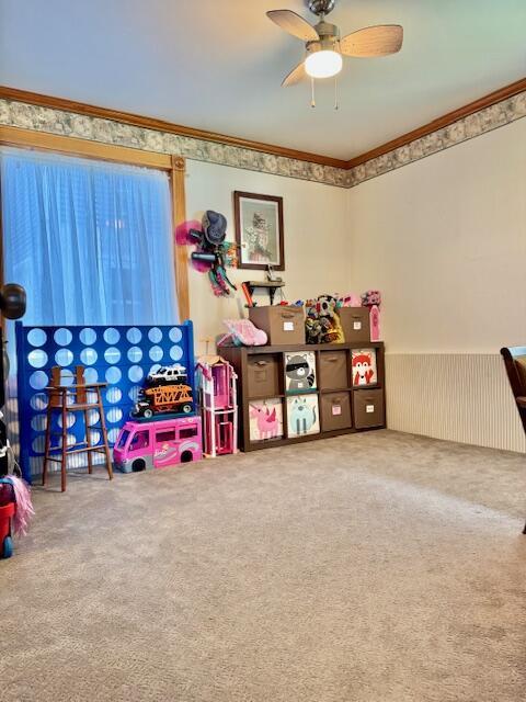 1022 Ottland Shrs, Lake Odessa, MI 48849 - game room with crown molding, carpet floors, a ceiling fan, and wainscoting