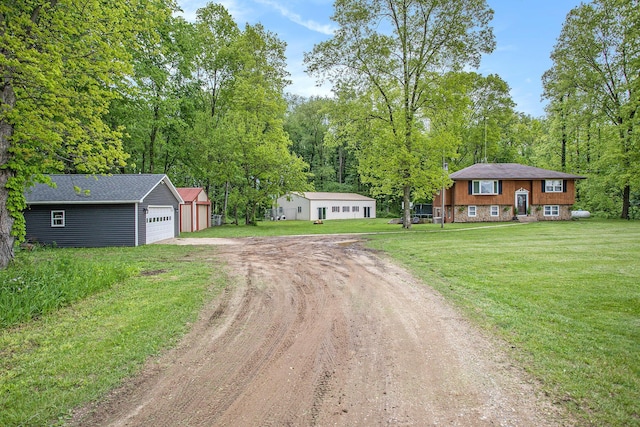 7920 8 1/2 Mile Rd, Ceresco, MI 49033 - view of front of house with driveway, an outdoor structure, a front yard, and a garage