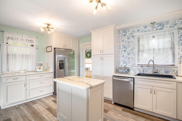 7920 8 1/2 Mile Rd, Ceresco, MI 49033 - kitchen featuring stainless steel appliances, a sink, light wood finished floors, and a center island