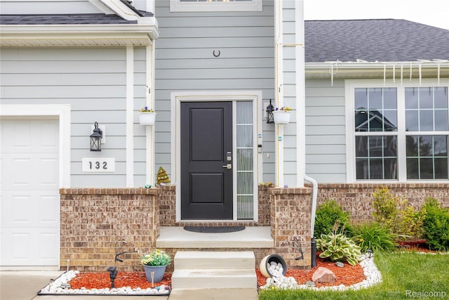132 Copper Ridge Ct, Walled Lake, MI 48390 - doorway to property with roof with shingles, a garage, and brick siding