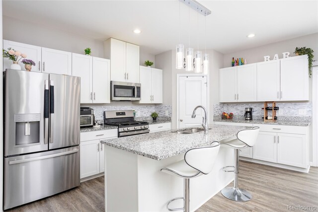 132 Copper Ridge Ct, Walled Lake, MI 48390 - kitchen featuring appliances with stainless steel finishes, a sink, backsplash, light wood-style floors, and recessed lighting