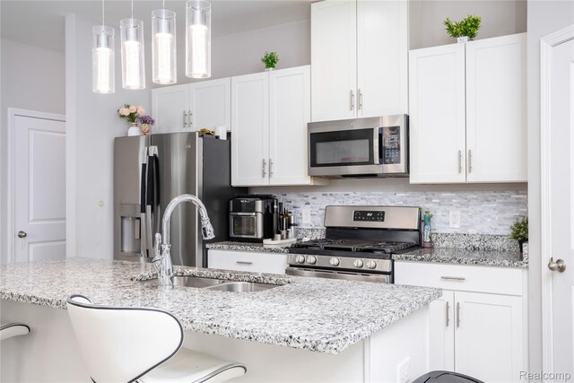 132 Copper Ridge Ct, Walled Lake, MI 48390 - kitchen featuring stainless steel appliances, a sink, decorative backsplash, and white cabinetry