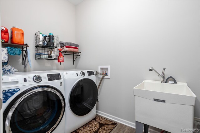 132 Copper Ridge Ct, Walled Lake, MI 48390 - washroom featuring washer and dryer, baseboards, and wood finished floors
