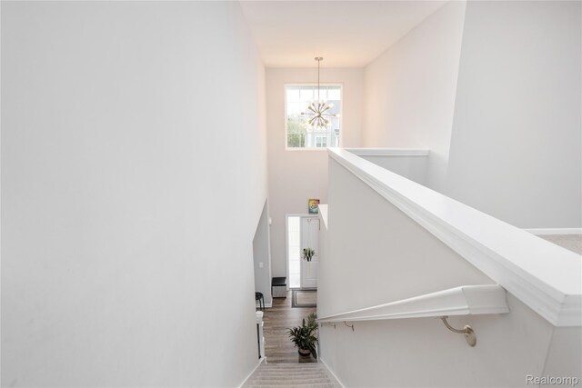 132 Copper Ridge Ct, Walled Lake, MI 48390 - stairs featuring a chandelier and baseboards