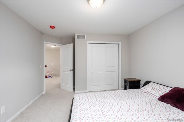 132 Copper Ridge Ct, Walled Lake, MI 48390 - bedroom with light carpet, a closet, and baseboards