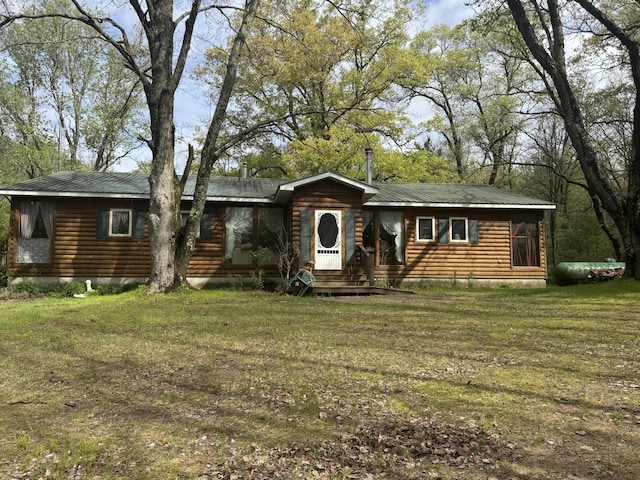 7215 E Niemitalo Dr, Chase, MI 49623 - view of front facade featuring log veneer siding, a front yard, and metal roof