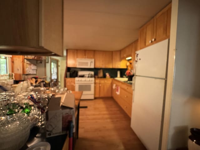 7215 E Niemitalo Dr, Chase, MI 49623 - kitchen with white appliances, light wood-style flooring, and light brown cabinetry