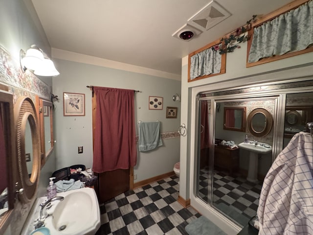 7215 E Niemitalo Dr, Chase, MI 49623 - bathroom with toilet, a shower stall, tile patterned floors, and baseboards
