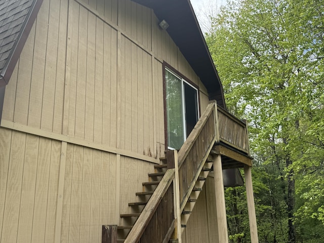 7215 E Niemitalo Dr, Chase, MI 49623 - view of property exterior with a shingled roof and stairway