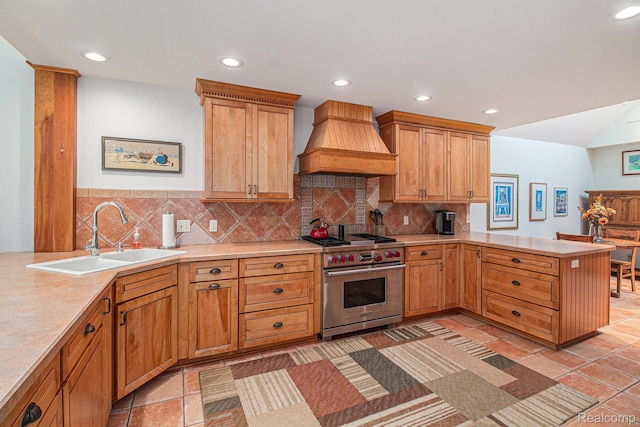 9095 S Saginaw Rd Unit 10, Grand Blanc, MI 48439 - kitchen with premium range, premium range hood, a sink, a peninsula, and recessed lighting