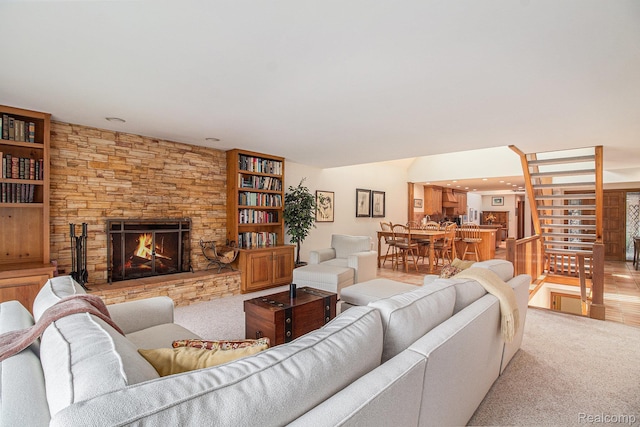 9095 S Saginaw Rd Unit 10, Grand Blanc, MI 48439 - living area with a fireplace, stairs, and carpet floors
