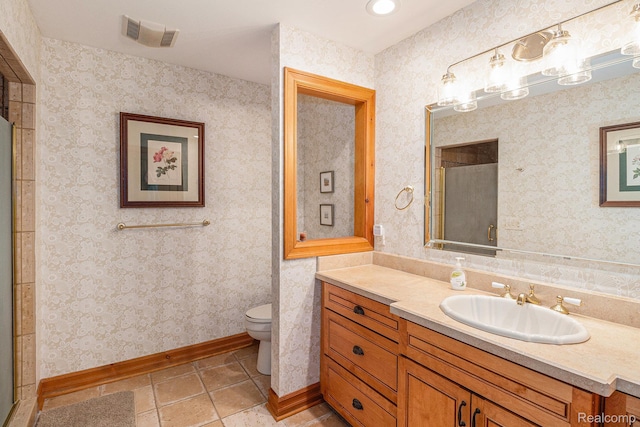 9095 S Saginaw Rd Unit 10, Grand Blanc, MI 48439 - bathroom with toilet, vanity, tile patterned floors, an enclosed shower, and baseboards