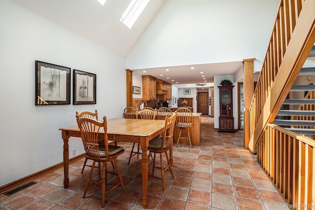 9095 S Saginaw Rd Unit 10, Grand Blanc, MI 48439 - dining room with a skylight, stairs, and high vaulted ceiling