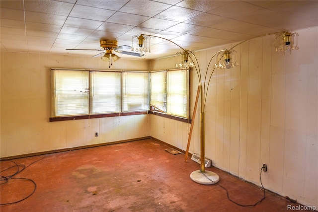 123 Parkdale Ave, Pontiac, MI 48340 - empty room with plenty of natural light, ceiling fan, wood walls, and concrete flooring