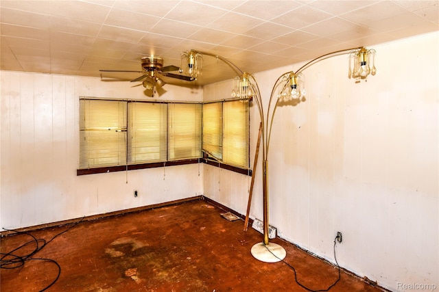 123 Parkdale Ave, Pontiac, MI 48340 - unfurnished room featuring a ceiling fan, wooden walls, and concrete flooring