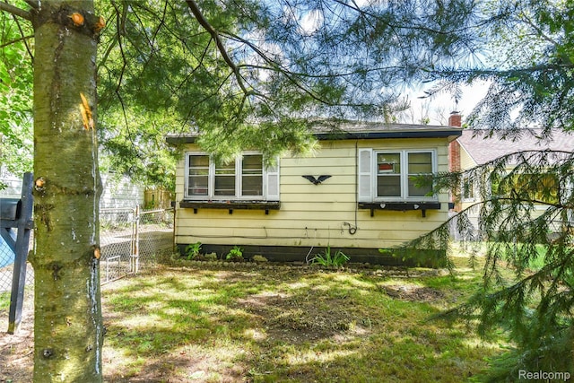 123 Parkdale Ave, Pontiac, MI 48340 - rear view of house with a gate and a chimney