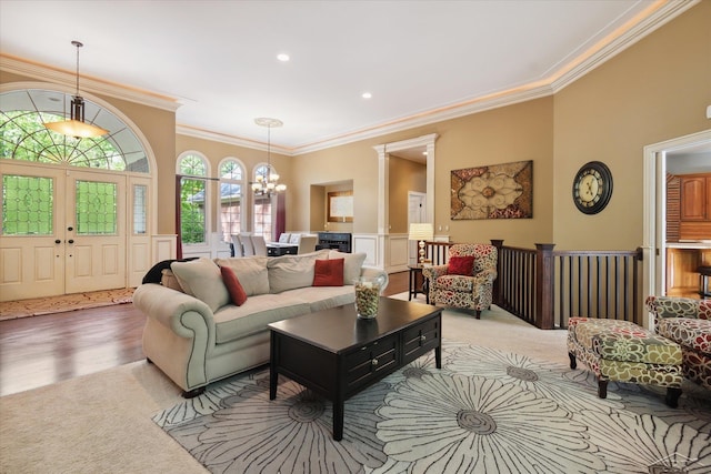 3283 Foxfire Dr, Milford, MI 48380 - carpeted living room featuring ornamental molding, a chandelier, wainscoting, recessed lighting, and a decorative wall