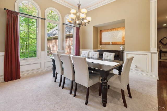 3283 Foxfire Dr, Milford, MI 48380 - carpeted dining space with a decorative wall, a chandelier, ornamental molding, and a wainscoted wall