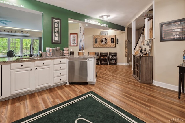 3283 Foxfire Dr, Milford, MI 48380 - kitchen with dishwasher, a sink, white cabinets, light wood-style floors, and baseboards