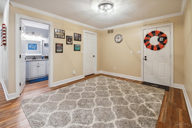 3283 Foxfire Dr, Milford, MI 48380 - entrance foyer with ornamental molding, wood finished floors, and baseboards