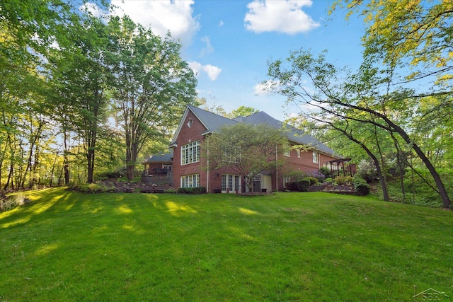3283 Foxfire Dr, Milford, MI 48380 - view of side of home featuring brick siding and a yard