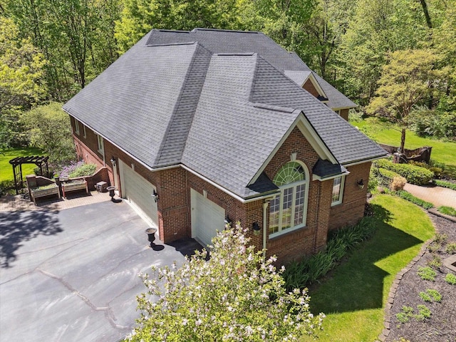 3283 Foxfire Dr, Milford, MI 48380 - view of front facade with brick siding, asphalt driveway, a forest view, and a shingled roof