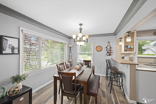 4851 Consear Rd, Ottawa Lake, MI 49267 - dining space featuring a chandelier, plenty of natural light, dark wood finished floors, and baseboards