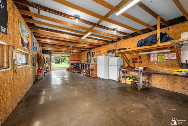 4851 Consear Rd, Ottawa Lake, MI 49267 - garage featuring freestanding refrigerator and a workshop area