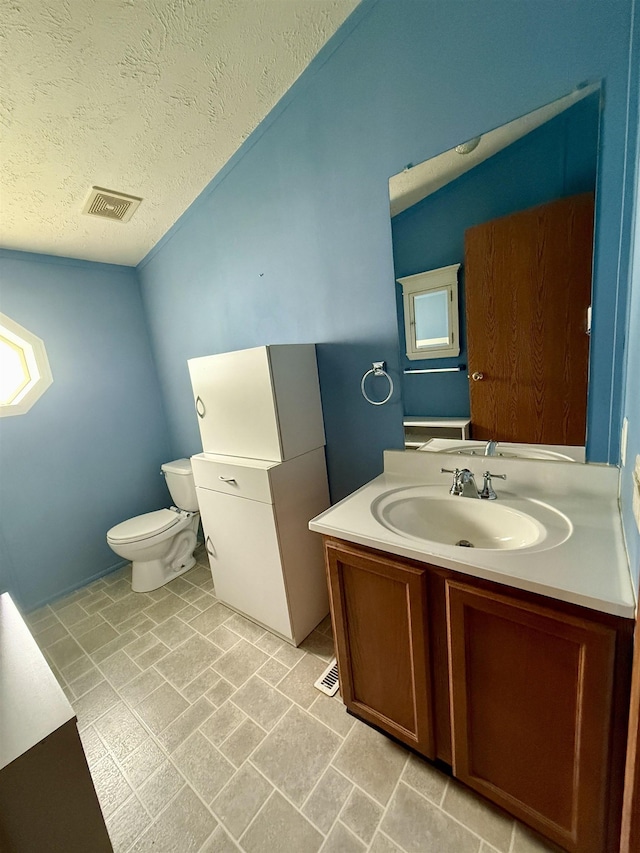 59 Clydesdale Dr, Mount Morris, MI 48458 - half bath featuring toilet, vanity, a textured ceiling, and plenty of natural light