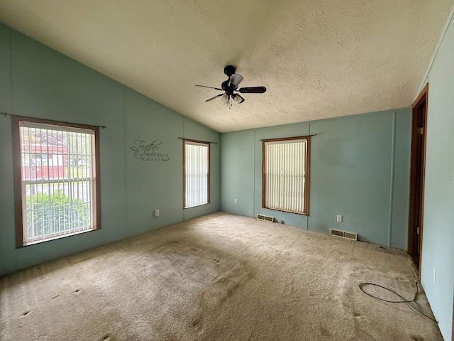 59 Clydesdale Dr, Mount Morris, MI 48458 - empty room with lofted ceiling, ceiling fan, a textured ceiling, and carpet flooring