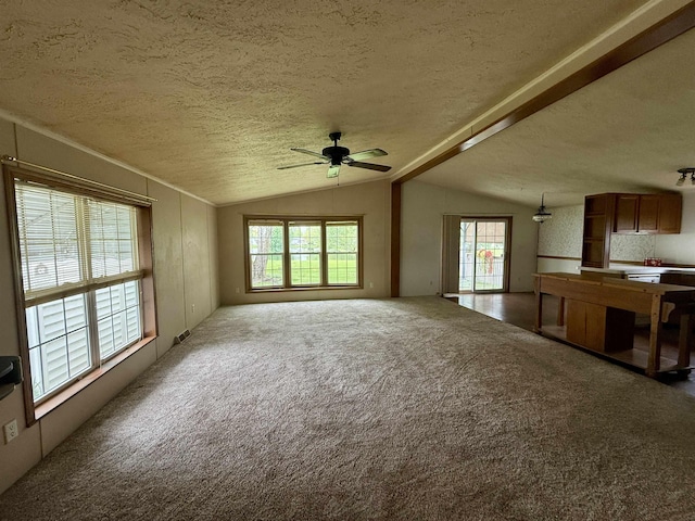 59 Clydesdale Dr, Mount Morris, MI 48458 - unfurnished living room with lofted ceiling, a ceiling fan, a textured ceiling, healthy amount of natural light, and carpet floors