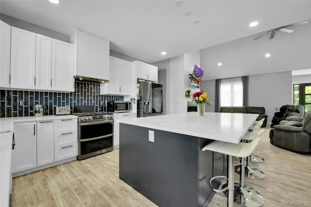 44200 Judd Rd, Belleville, MI 48111 - kitchen featuring stainless steel appliances, open floor plan, light wood-type flooring, a kitchen island, and recessed lighting