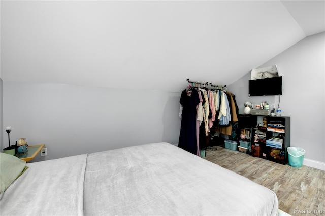 44200 Judd Rd, Belleville, MI 48111 - bedroom with wood finished floors, vaulted ceiling, and baseboards