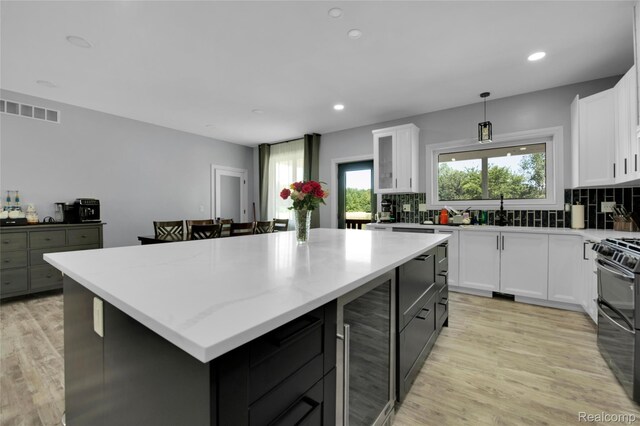 44200 Judd Rd, Belleville, MI 48111 - kitchen featuring wine cooler, a center island, decorative backsplash, white cabinetry, and recessed lighting