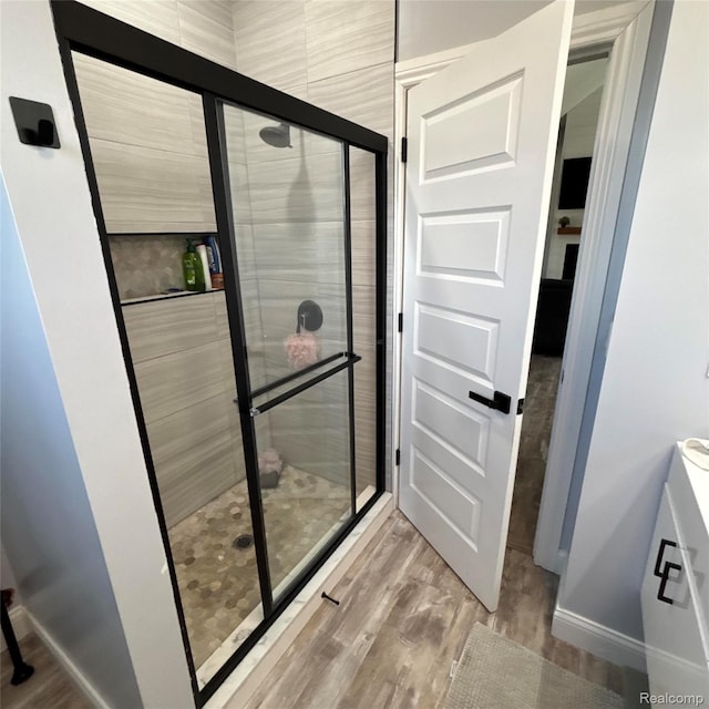 44200 Judd Rd, Belleville, MI 48111 - full bath featuring wood finished floors, vanity, and a shower stall