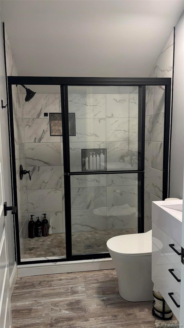 44200 Judd Rd, Belleville, MI 48111 - full bath with a marble finish shower, vanity, wood finished floors, and toilet