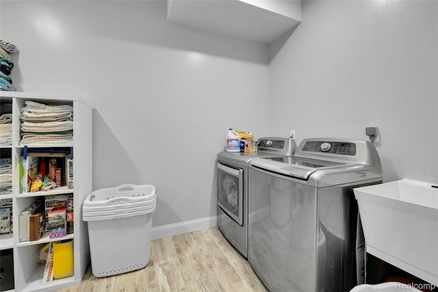 44200 Judd Rd, Belleville, MI 48111 - washroom featuring washing machine and clothes dryer, wood finished floors, and baseboards