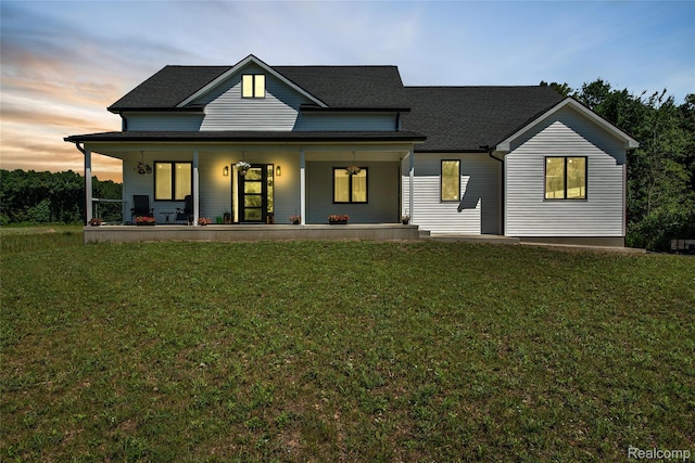 44200 Judd Rd, Belleville, MI 48111 - view of front facade with covered porch, a lawn, and roof with shingles