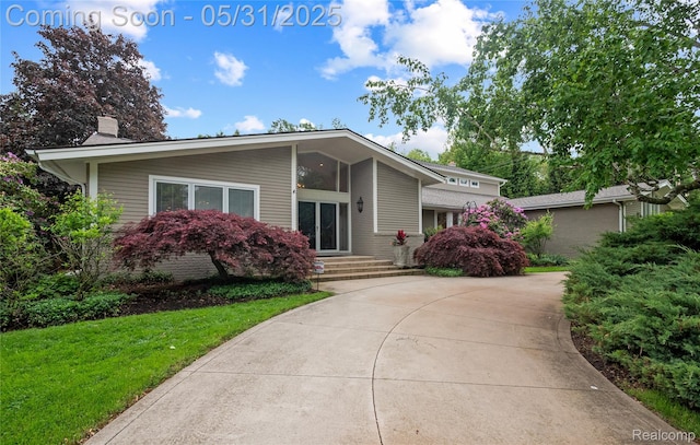 4495 Stony River Dr, Bloomfield Hills, MI 48301 - mid-century inspired home featuring a chimney and a front lawn