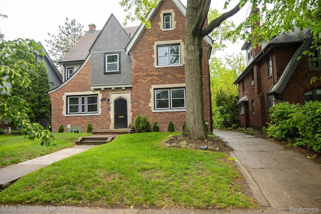 17352 Parkside St, Detroit, MI 48221 - tudor-style house with brick siding, a front lawn, a chimney, and stucco siding