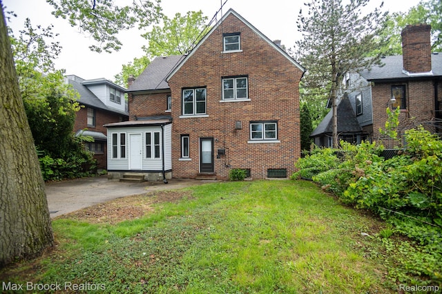 17352 Parkside St, Detroit, MI 48221 - rear view of house with entry steps, brick siding, and a lawn