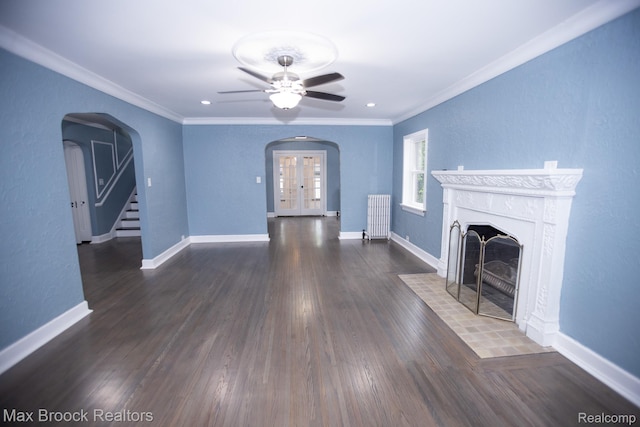 17352 Parkside St, Detroit, MI 48221 - unfurnished living room with radiator, arched walkways, a fireplace with flush hearth, a ceiling fan, and crown molding