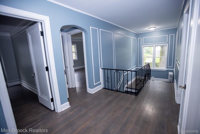 17352 Parkside St, Detroit, MI 48221 - hallway with an upstairs landing, arched walkways, dark wood-style floors, radiator heating unit, and baseboards
