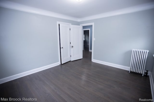 17352 Parkside St, Detroit, MI 48221 - spare room featuring radiator heating unit, dark wood-style floors, and baseboards