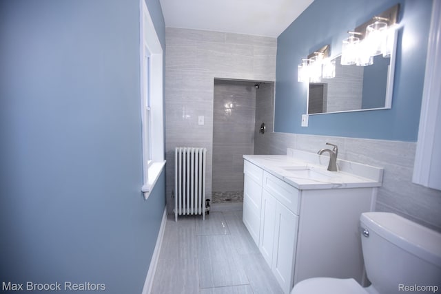 17352 Parkside St, Detroit, MI 48221 - full bathroom with radiator heating unit, vanity, tile walls, a tile shower, and toilet