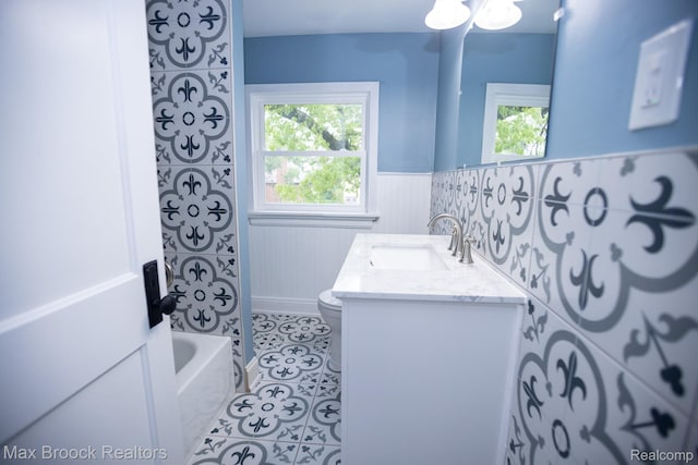 17352 Parkside St, Detroit, MI 48221 - full bathroom with wainscoting, toilet, double vanity, and tile patterned floors